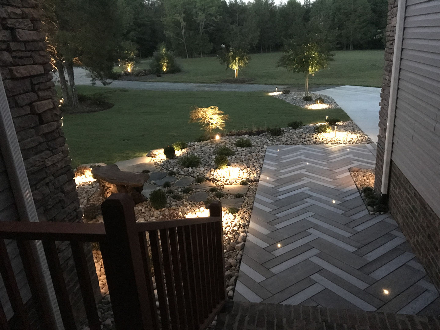 Outdoor lighting designs for a stone walkway and garden.