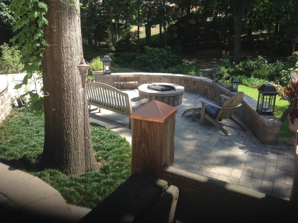 Handcrafted outdoor fire pit on a stone patio with seating