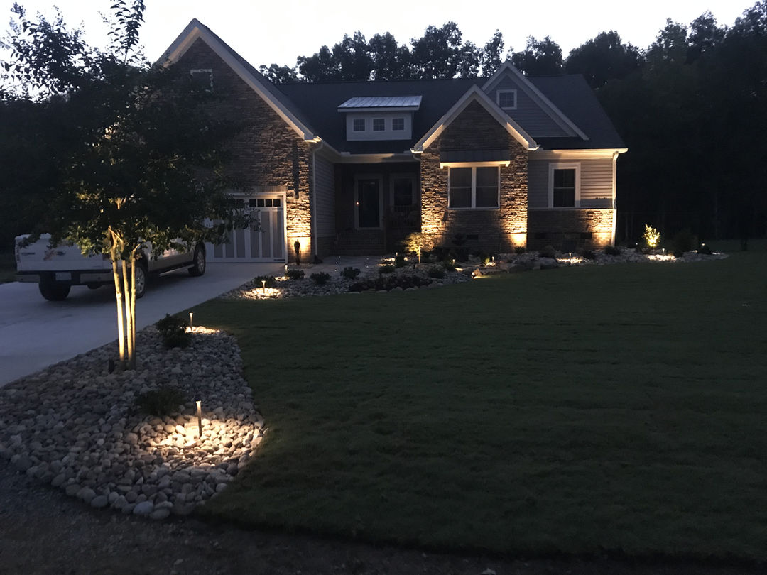 Modern home exterior with custom landscape lighting designs.