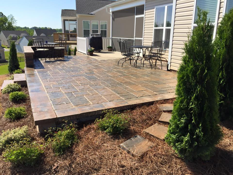Large stone paver patio with unique patio designs and seating.
